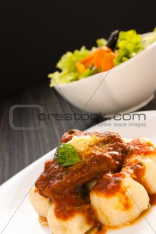 Beef with sauce and gnocchi