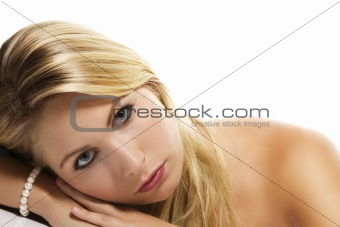 beautiful blonde woman laying her head on a table