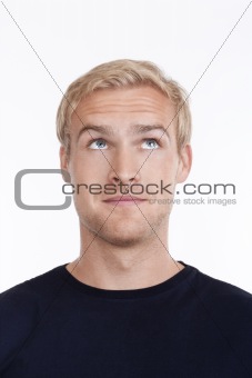 portrait of a young man with blond hair looking up - isolated on white