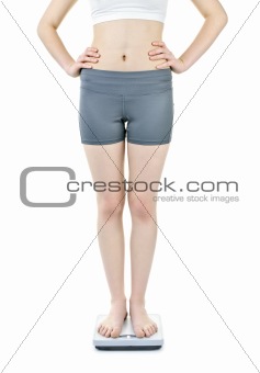 Woman standing on bathroom scale