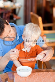 father and son having breakfast