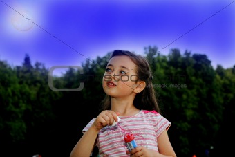 The little girl starts up soap bubbles