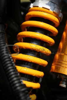 Yellow shock absorber of a quad bike