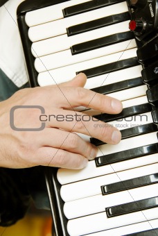 Musician hand playing accordion