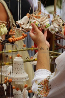 The girl chooses ceramic trinkets,