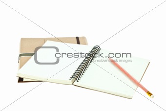 Isolated Light cream color paper note book on brown book and pen