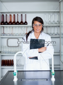 Portrait of a female scientist holding a clipboard