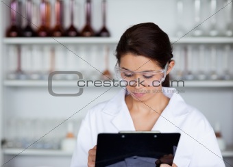 Scientist writing on a clipboard