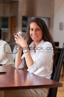 Portrait of a young woman having a coffee