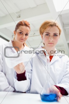 Portrait of cute science students doing an experiment