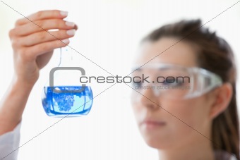 Close up of a scientist looking at flask