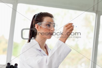 Young science student looking at a microscope slide