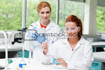 Cute science students doing an experiment