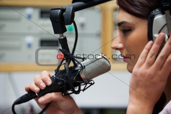 Close up of a cute singer recording a track