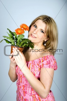 Pretty woman with orange house plant flower