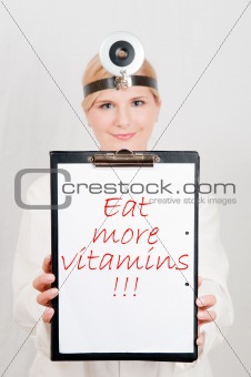 Beautiful female doctor giving health tips - eat more vitamins. 