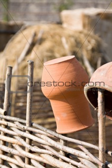 Clay jugs on fence