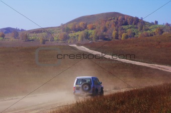 Off-road vehicle running in the grassland