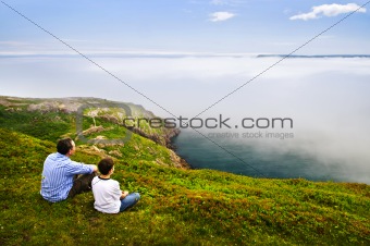 Father and son at ocean coast