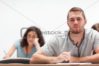 Smiling handsome student sitting