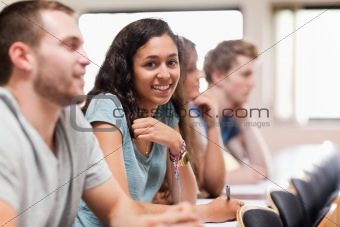 Smiling students listening a lecturer