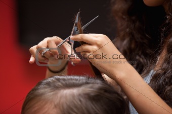 Close up of a hand cutting hair