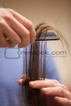 Close up of a hand combing hair