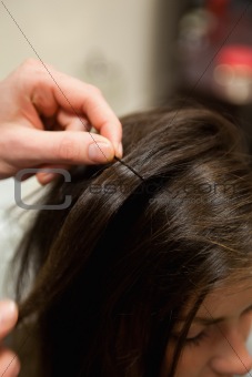 Portrait of a hairdresser putting a hairpin