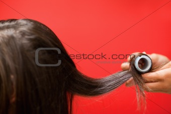 Close up of hands rolling hair