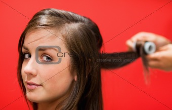 Woman having her hair rolled