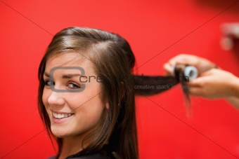 Smiling woman having her hair rolled