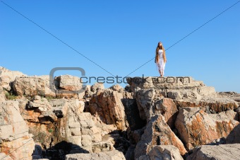 Girl standing on a cliff
