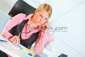 Business woman sitting at office desk and thinking 
