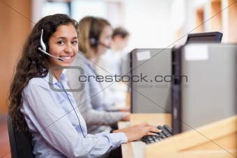 Smiling assistant working with a computer
