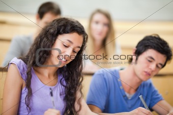 Smiling students writing