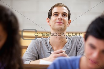 Smiling student listening to a lecturer