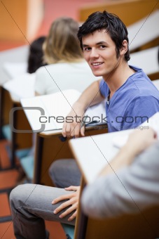 Portrait of a handsome young student being distracted
