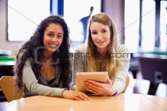 Cute friends posing with tablet computer