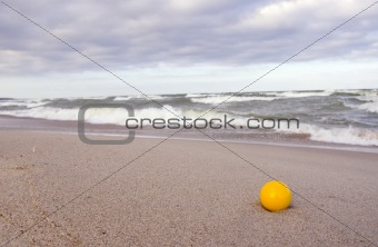 yellow ball on the sea beach sand