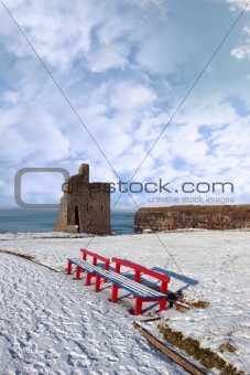 winters view of ballybunion castle and red benches