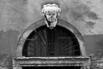 Bust above a worn doorway in Venice