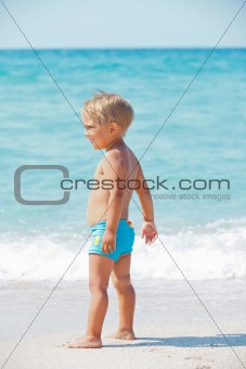 little boy and blue sea