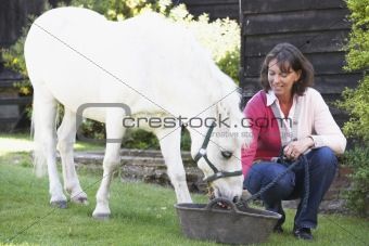 Farmer's Wife Feeding Pony