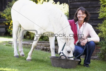 Farmer's Wife Feeding Pony