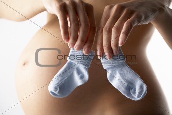 Pregnant Woman Holding Blue Baby Socks