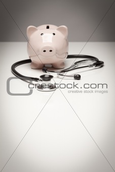 Piggy Bank and Stethoscope with Selective Focus on a Gradated Background.