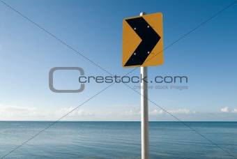 Yellow traffic sign at sea