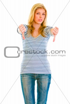 Upset teen girl showing thumbs down gesture

