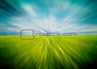 Abstract motion blurred meadow and sky with sun