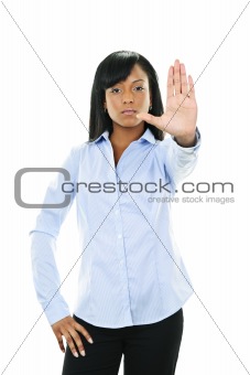Serious young woman giving stop gesture